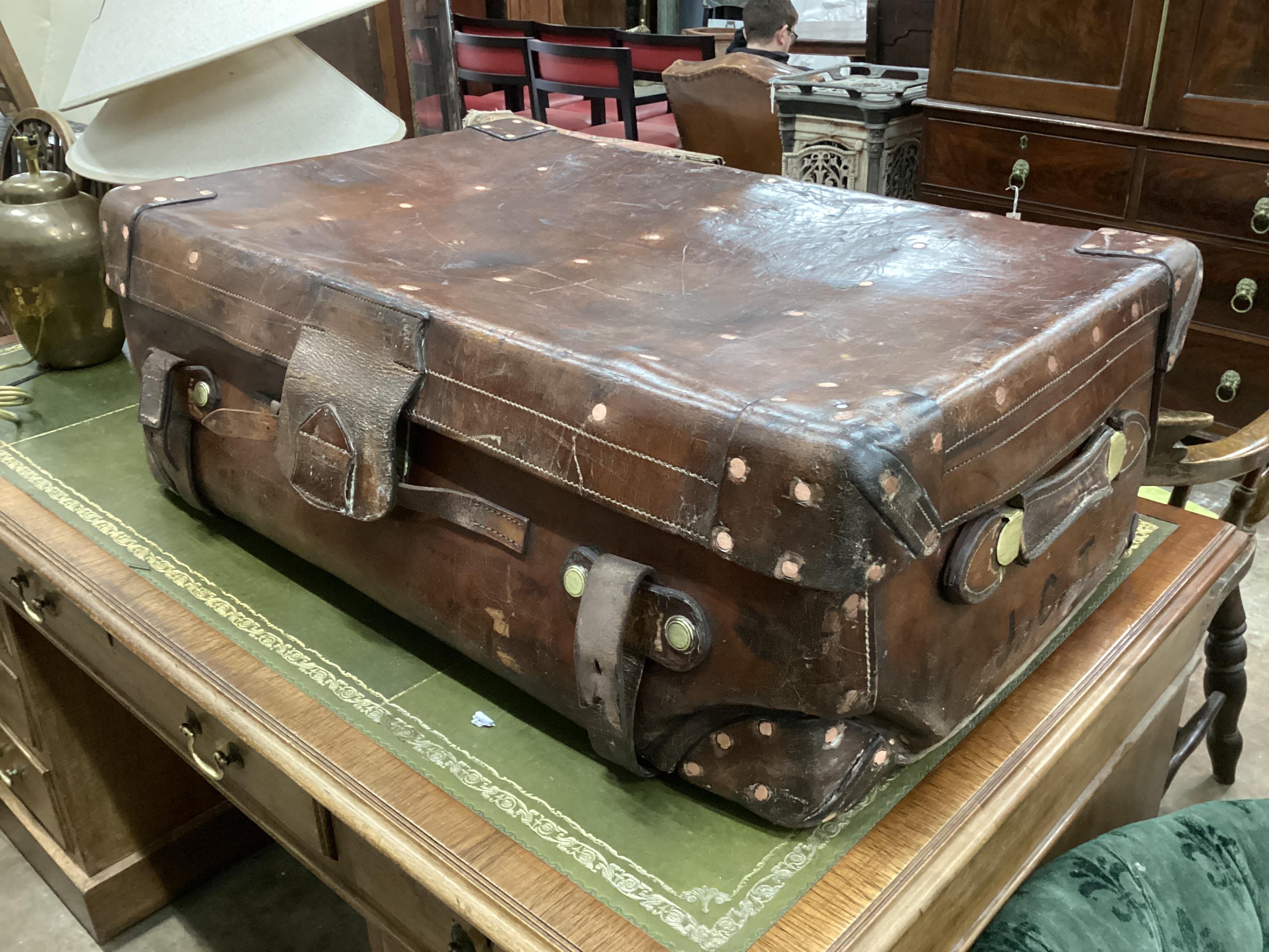 A Victorian leather brass and copper studded travelling trunk, width 86cm, depth 55cm, height 30cm